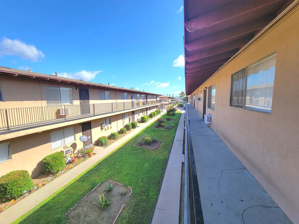 A sunny day at a residential complex with a clear blue sky.