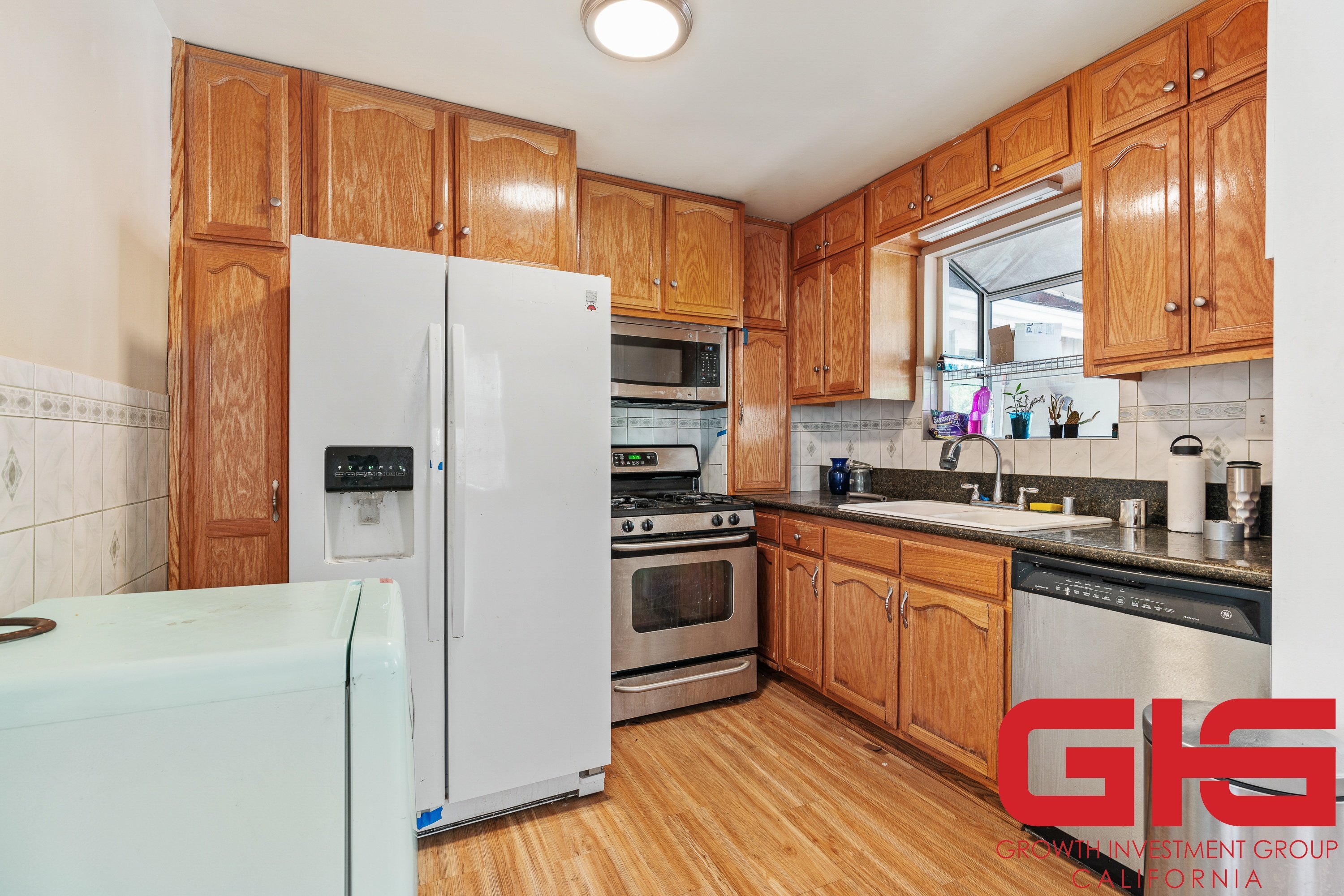 A kitchen with wooden cabinets and a white refrigerator.