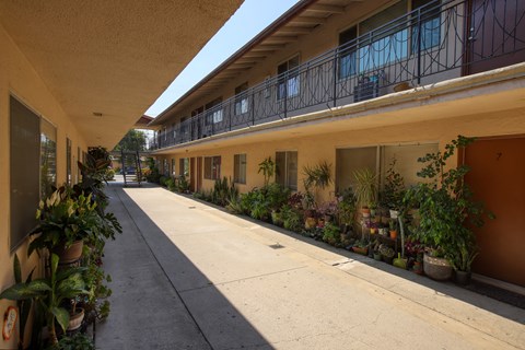A long, narrow balcony with a railing runs the length of a building.