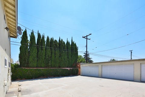 A clear blue sky above a row of garages.