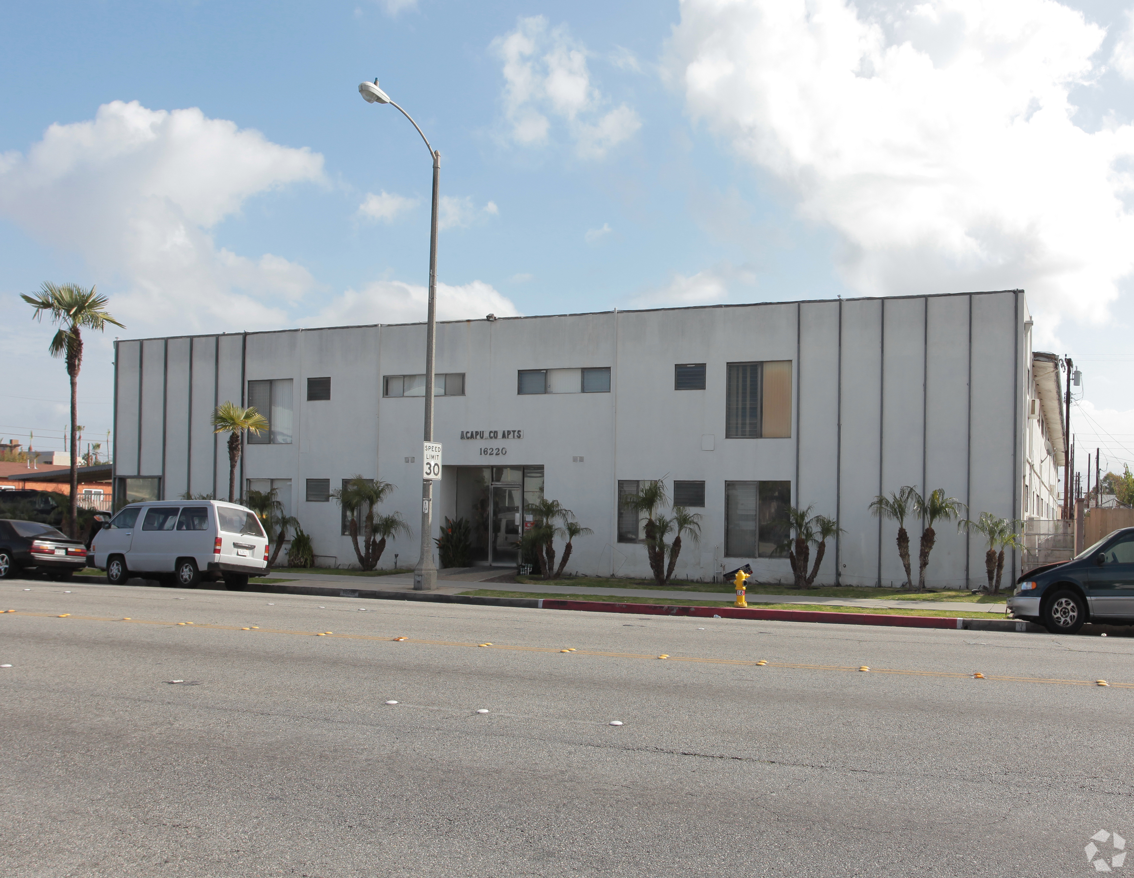 A white building with the name "Maple Hill" on it.