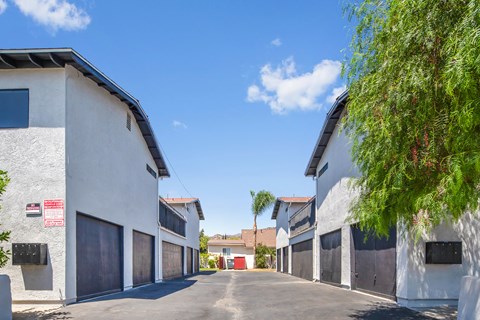 A row of white buildings with a red door in the middle.