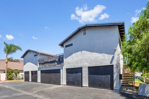 A two-story house with a garage and a balcony.