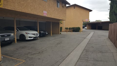 A parking lot with a white car parked in the middle.