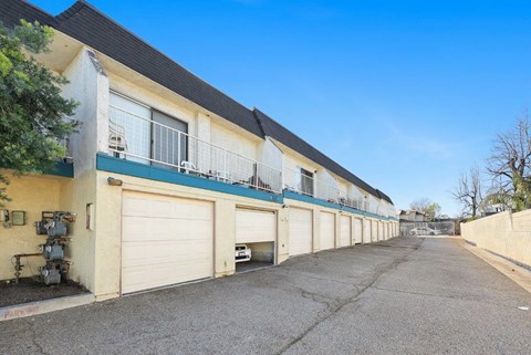A row of garage doors in front of a building.