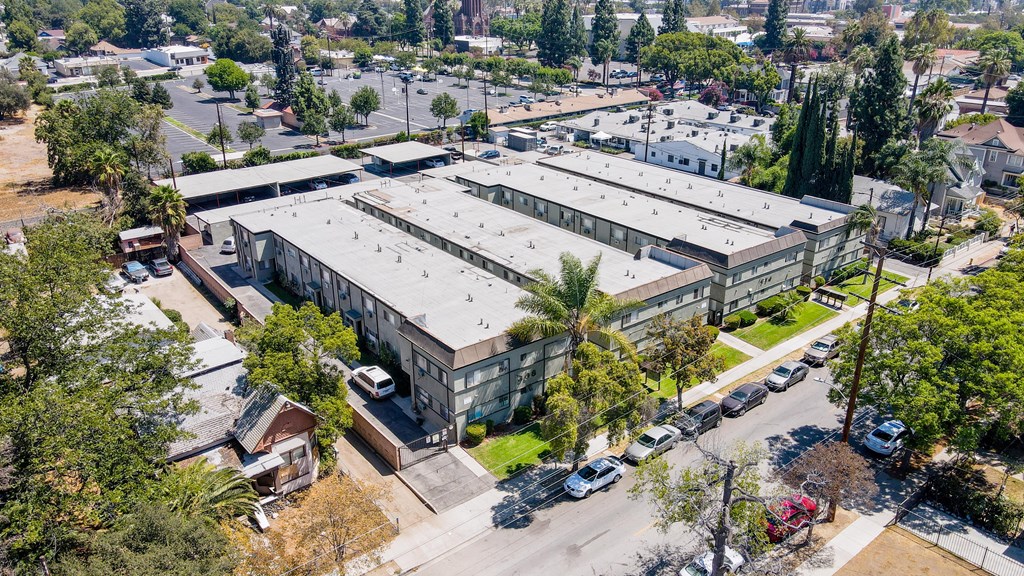A large industrial building with a parking lot in front.