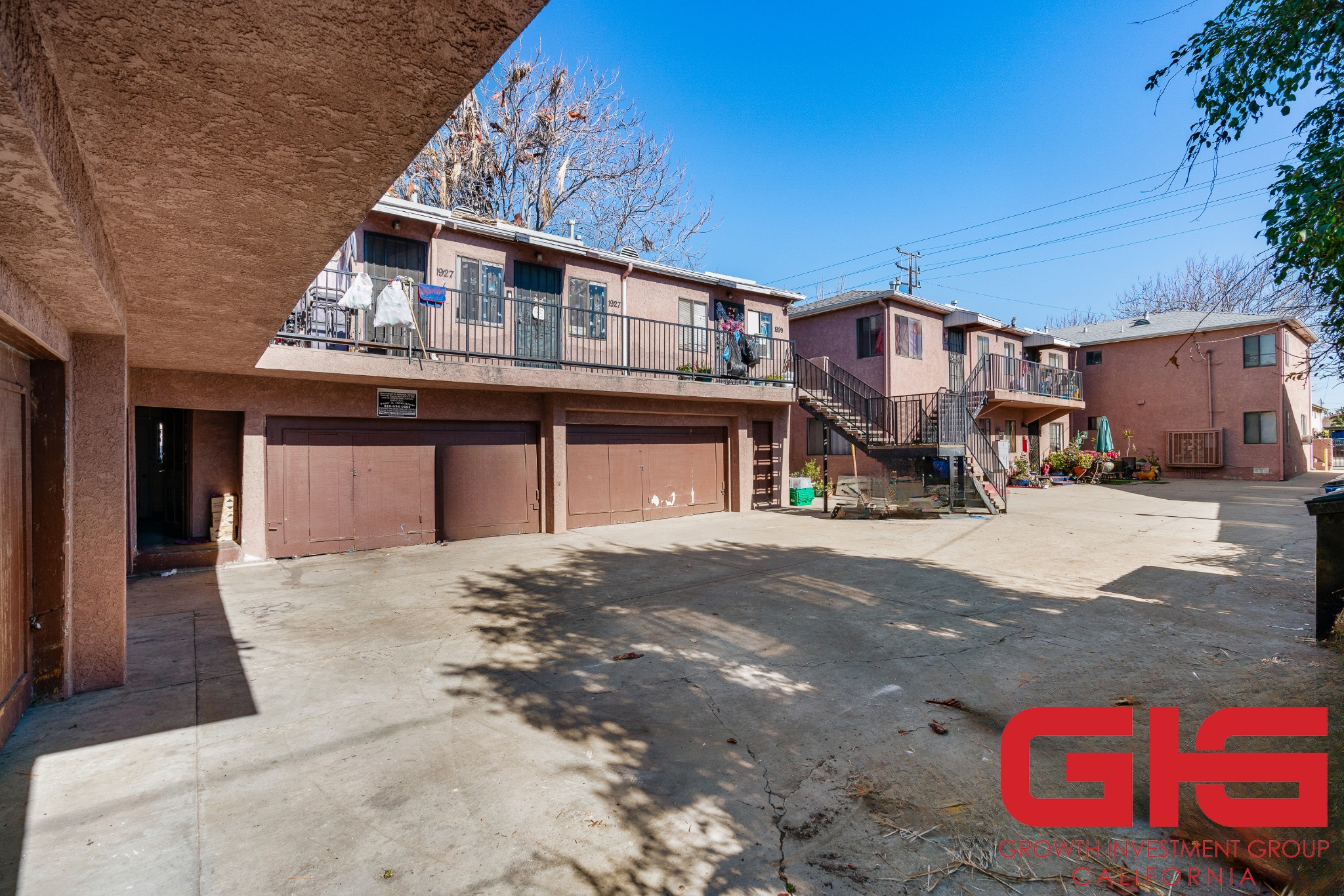 A sunny day at a residential complex with a clear blue sky.