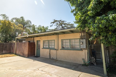 A house with a green door and a brown fence.