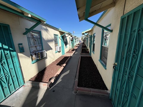 A row of houses with teal doors and windows.
