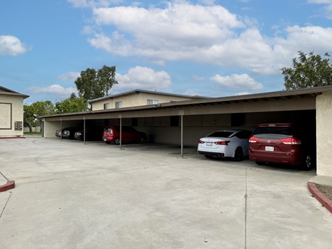 A parking garage with a few cars parked in it.