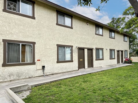 A row of houses with brown windows and doors.