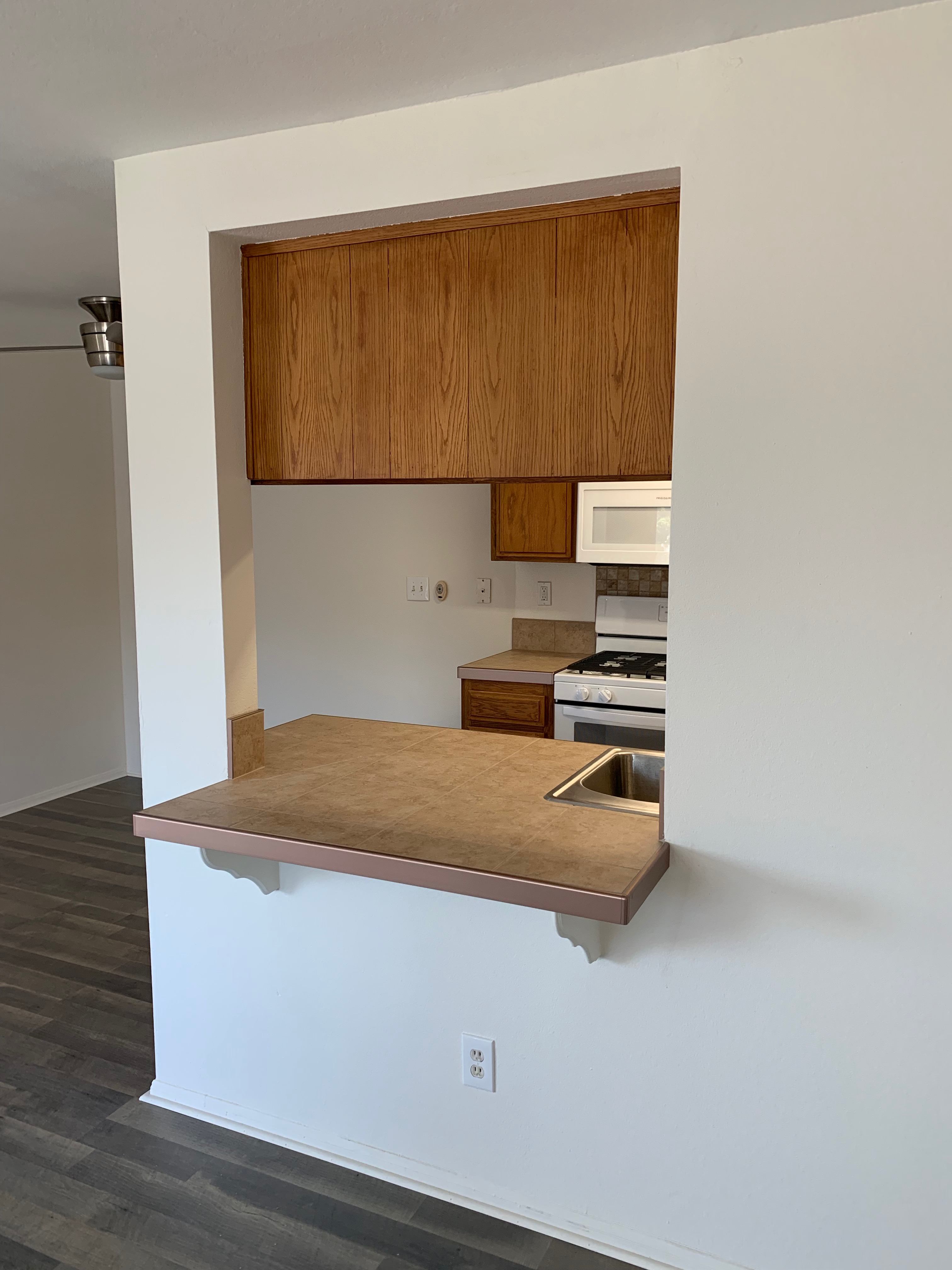 A kitchen with a wooden cabinet and countertop.