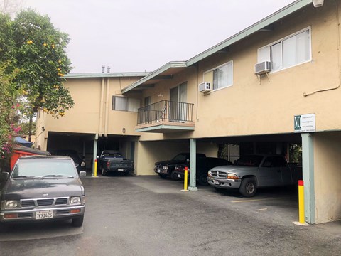 A parking garage with a few cars parked in it.