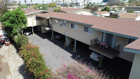 A car is parked in the driveway of a house.