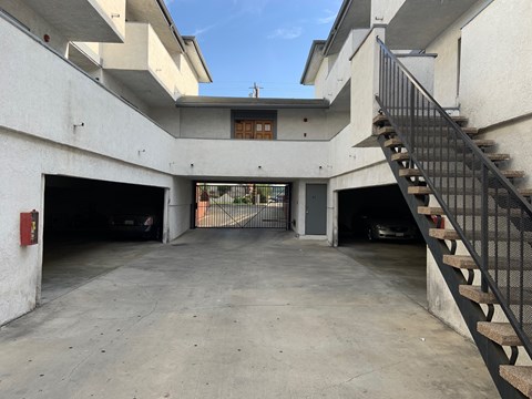 A parking garage with a staircase on the right side.
