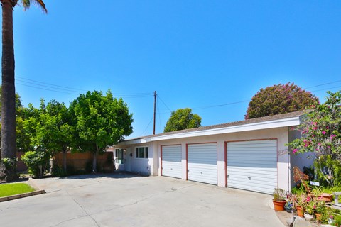 A two-car garage with a white exterior and a brown roof.