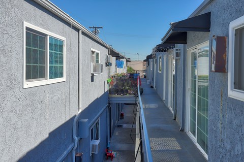 A row of houses with a blue sky in the background.