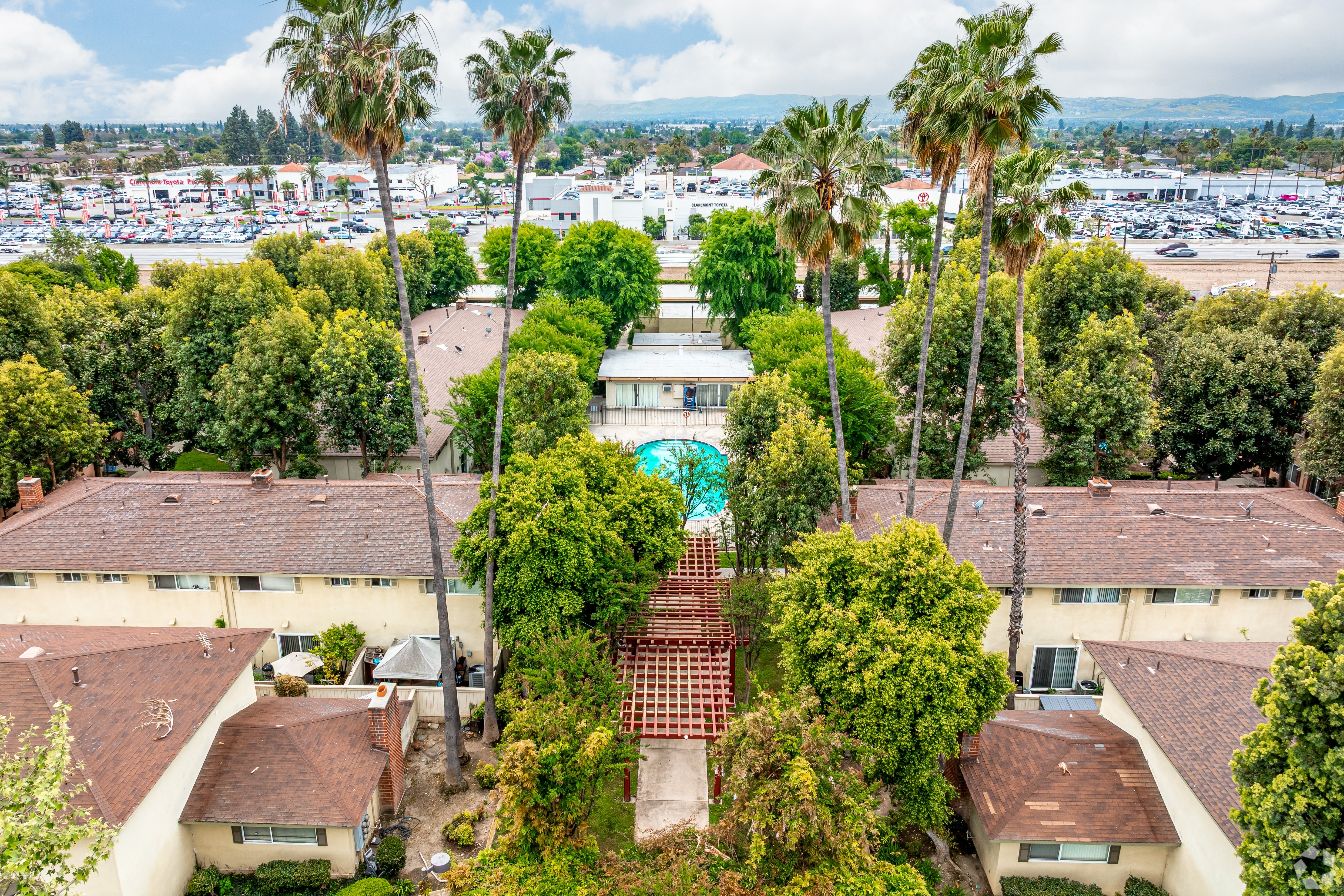 A view of a courtyard surrounded by houses and trees.