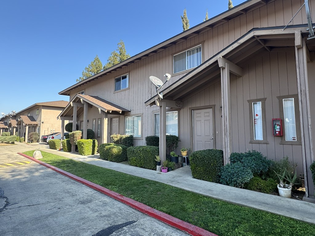A row of houses with a red line down the middle of the street.