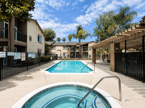 A pool in a courtyard surrounded by buildings.