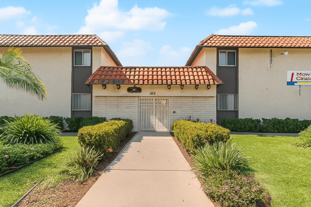A building with a red tile roof and a sign that says "Mow Careful".