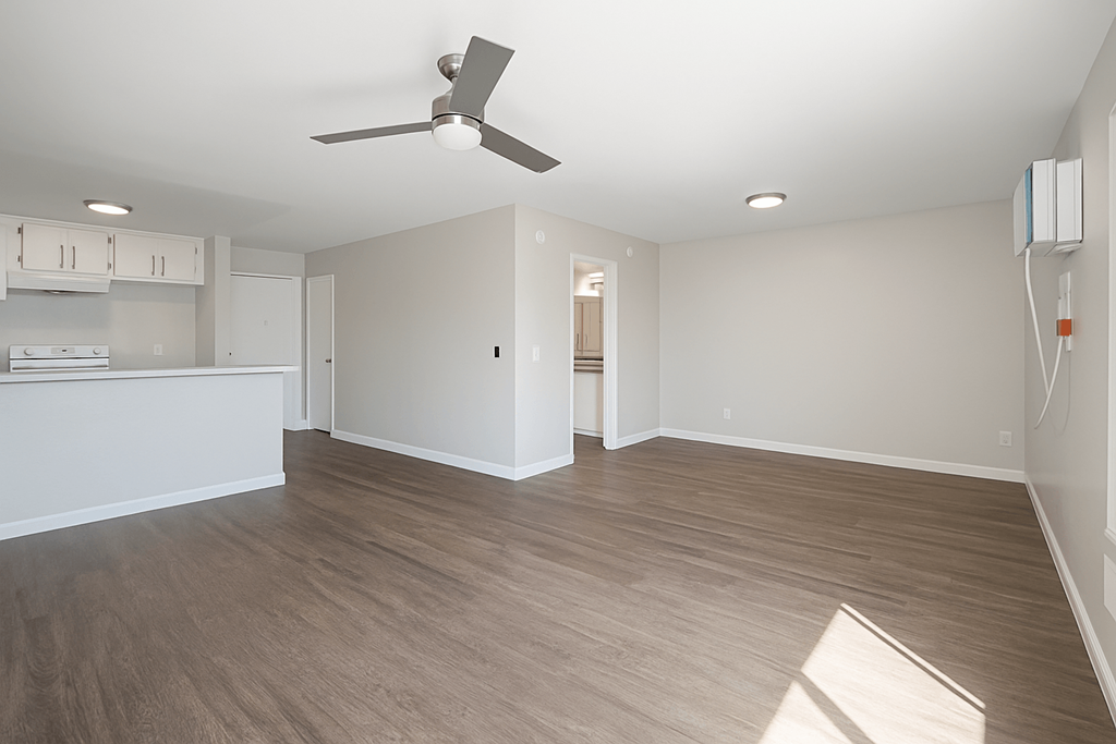 A room with a ceiling fan and lighting fixtures.