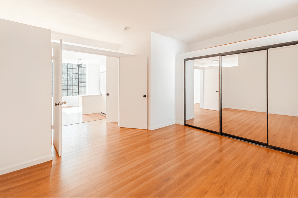 A room with wooden floors and white walls.