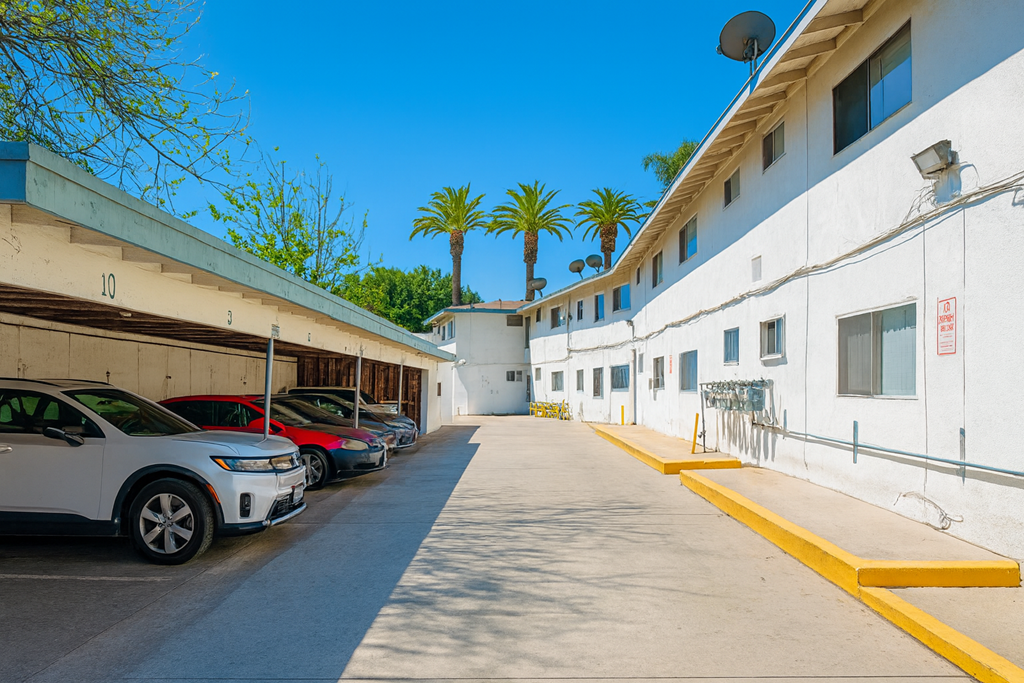 A row of cars are parked in a parking lot.