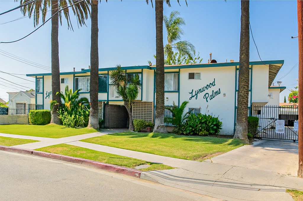 A Lynwood Palms sign is on the side of a building.