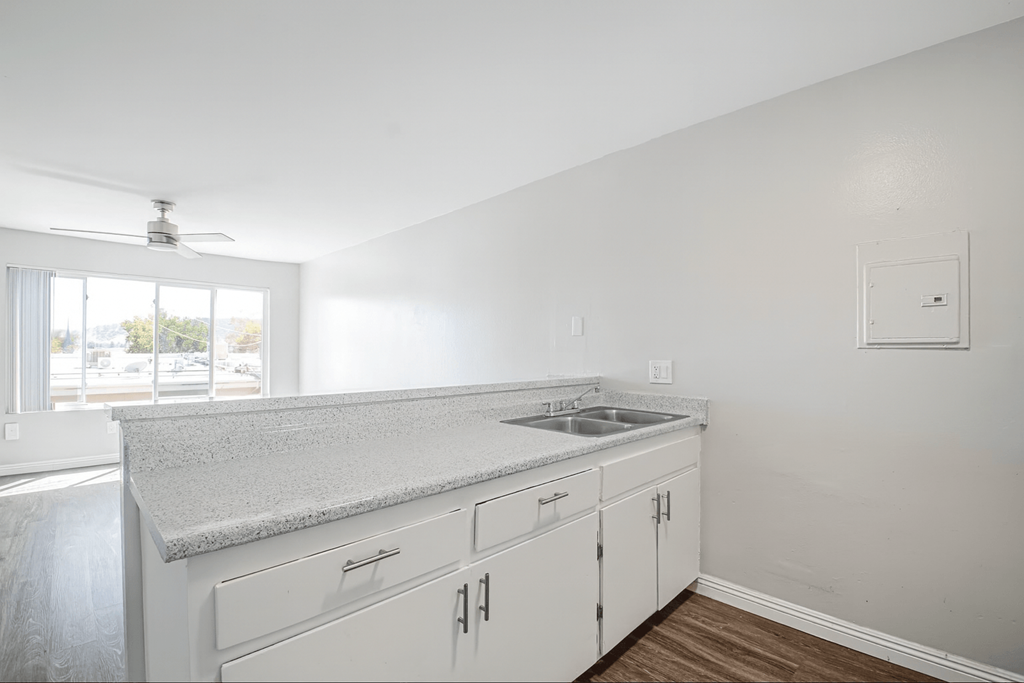 A kitchen with white cabinets and a countertop.