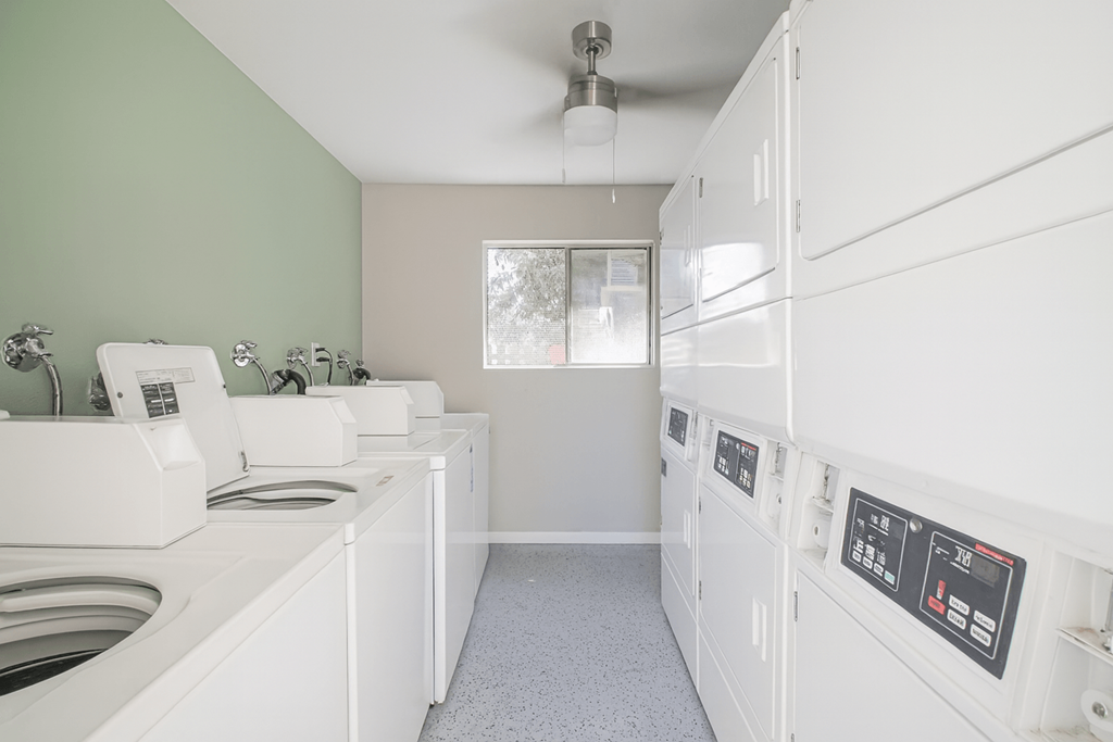 A row of washing machines in a laundromat.