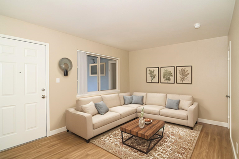 A living room with a white couch and a coffee table.