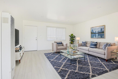A living room with a couch, chair, and coffee table.