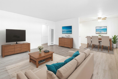 A living room with a brown couch and a wooden coffee table.