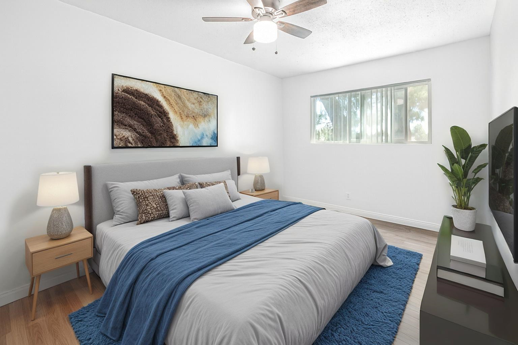 A bedroom with a large bed and a painting on the wall.