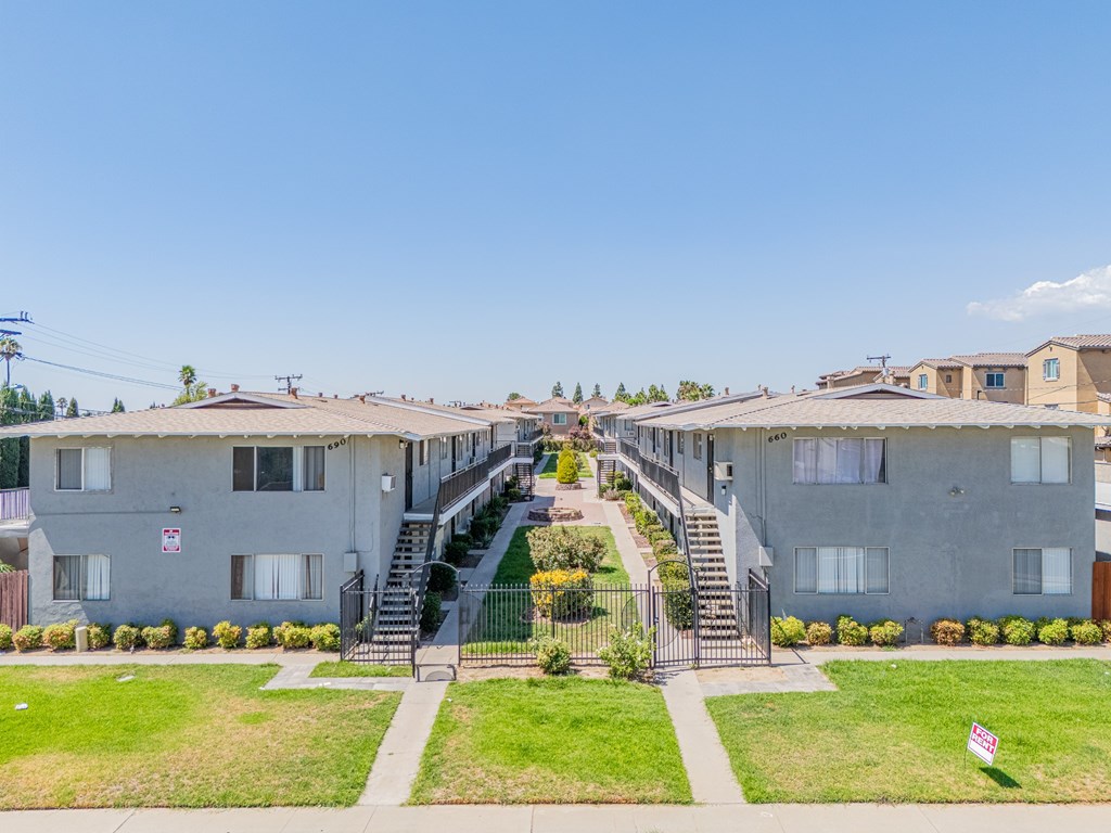 Apartment complex with a staircase leading to the entrance.