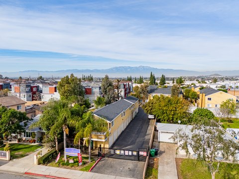 A residential area with houses and a mountain in the distance.