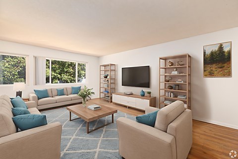 A living room with a large couch, a coffee table, and a television.