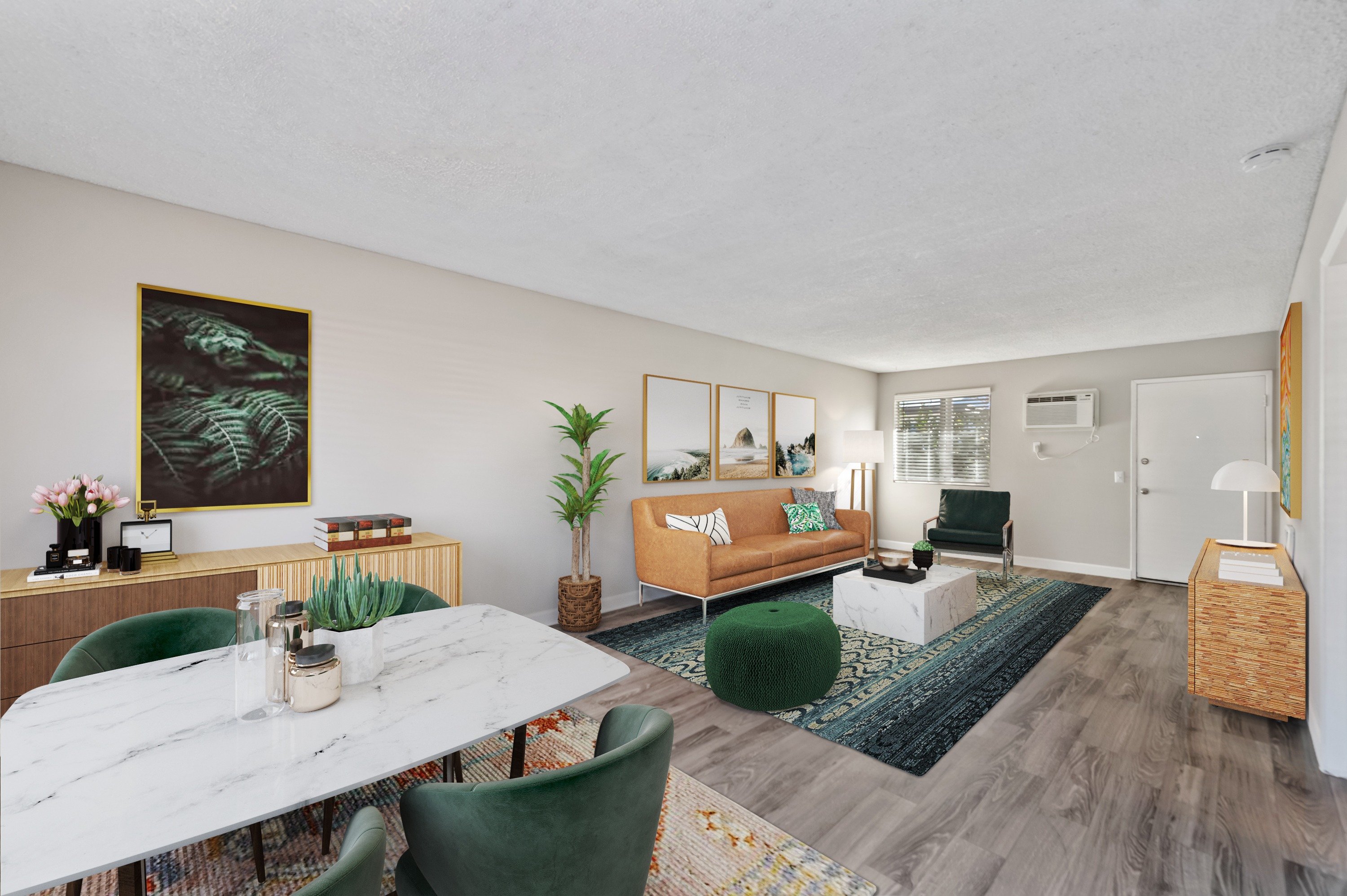 A living room with a white marble table and green chairs.