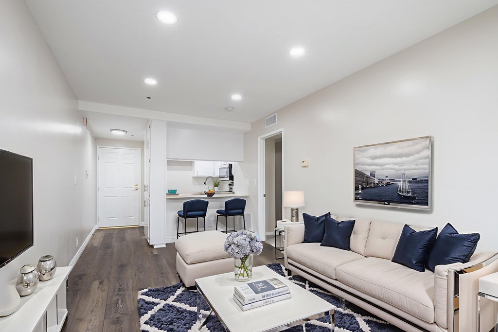 A modern living room with a white sofa and a coffee table.