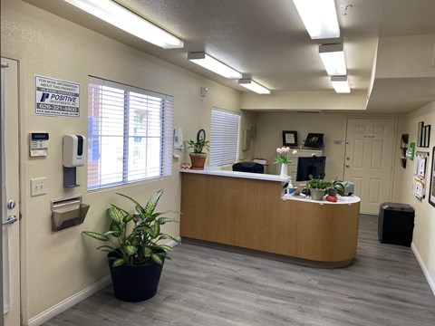 A reception area with a sign that says "POSITIVE" on the wall.