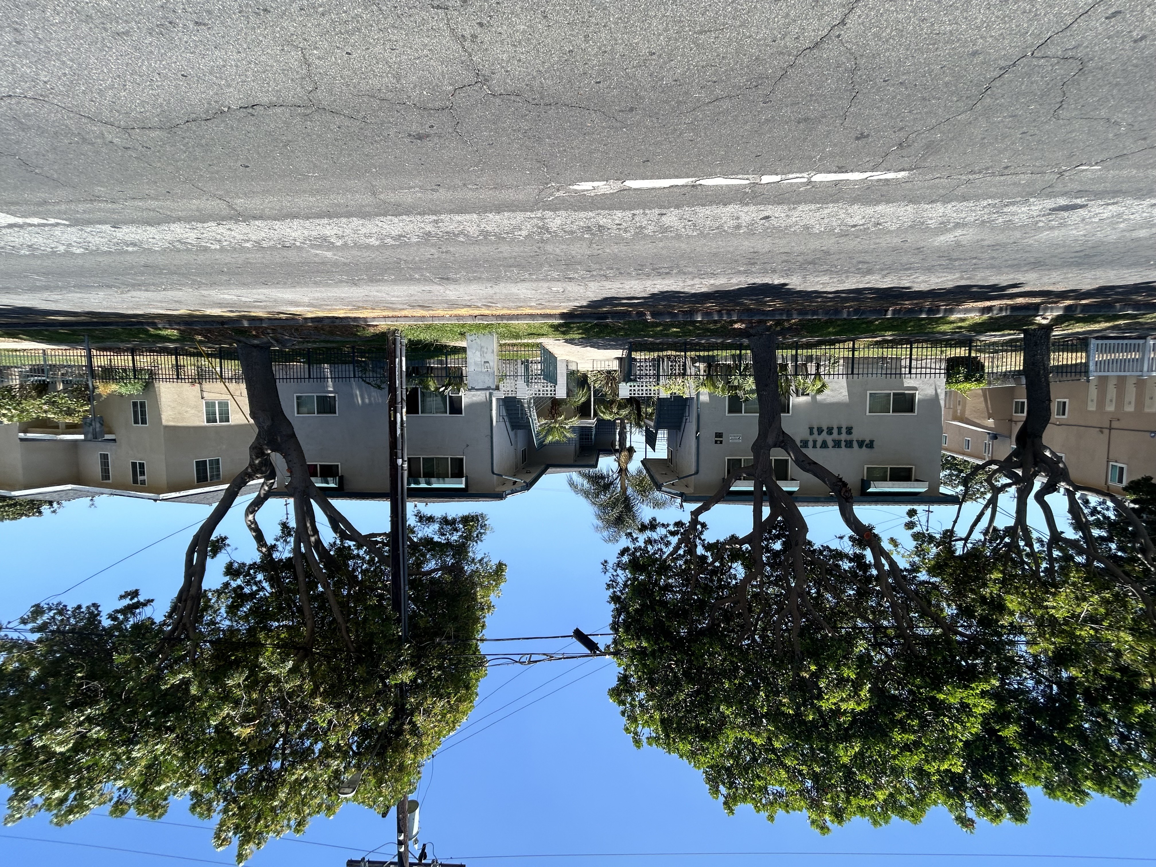 A reflection of houses and trees in a body of water.