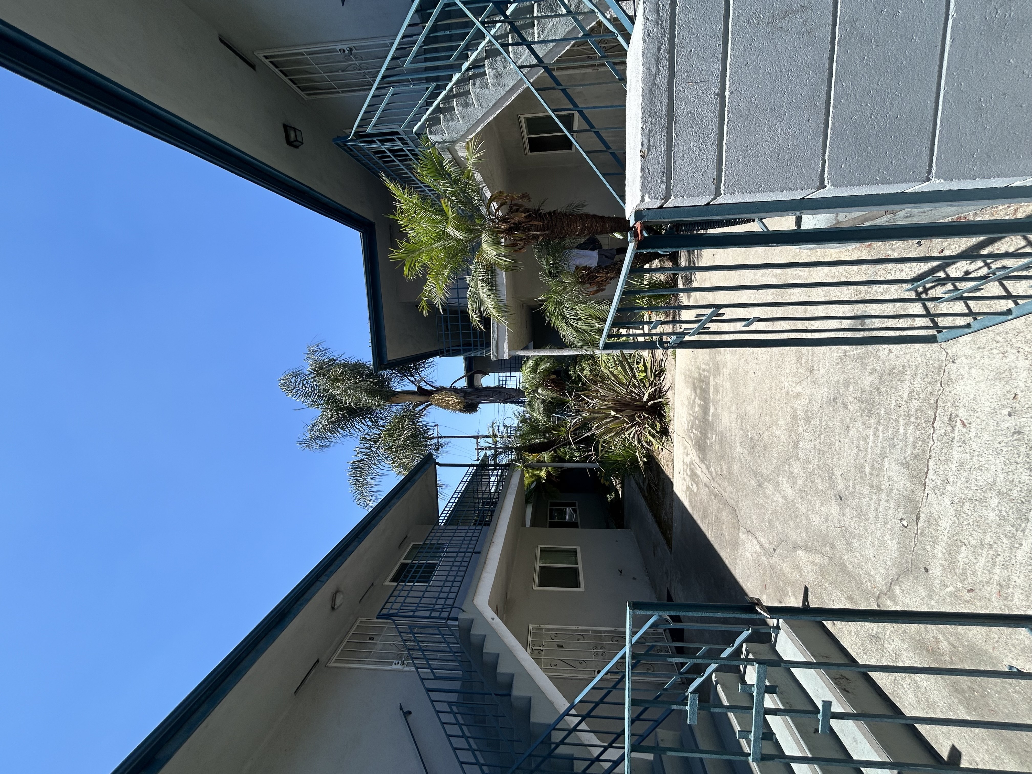 A building with a metal staircase and a clear blue sky.