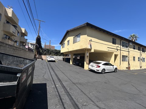 A white car is parked in a parking lot.