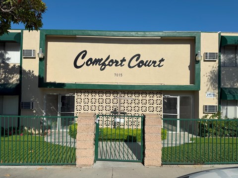 Comfort Court is a building with a green fence in front.