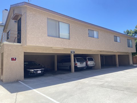 A building with a parking garage underneath it.