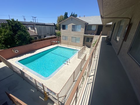 A small pool in a backyard with a metal fence around it.