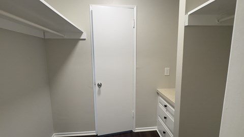 A white door is in a room with white walls.