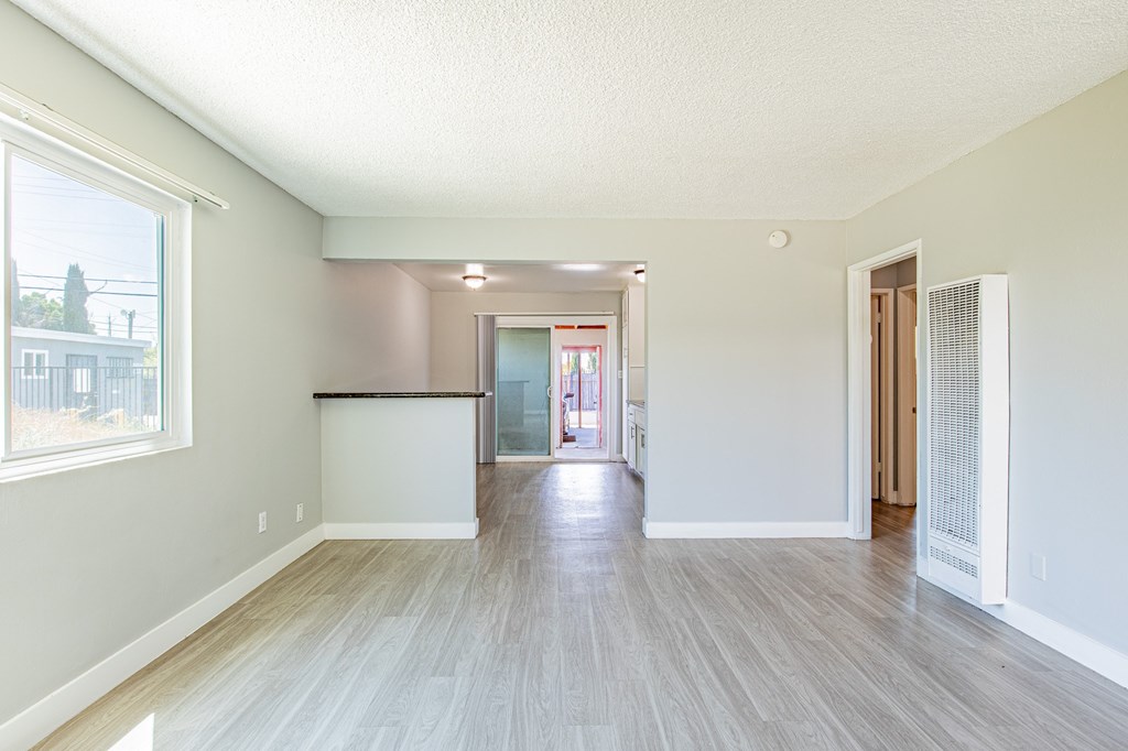 A room with a wooden floor and white walls.