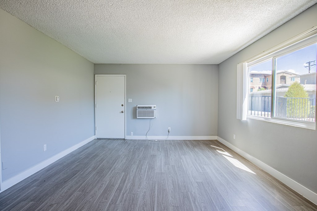 A room with a grey floor and a white door.